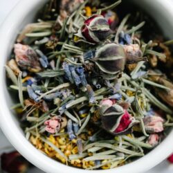 A bowl of mixed dried flowers and herbs used in tea blending