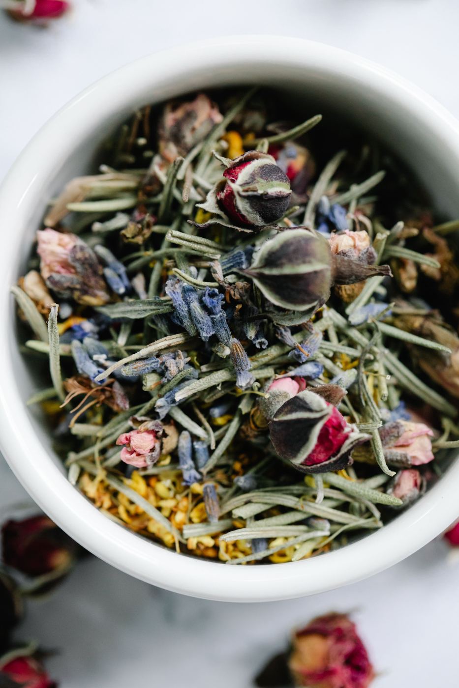 A bowl of mixed dried flowers and herbs used in tea blending