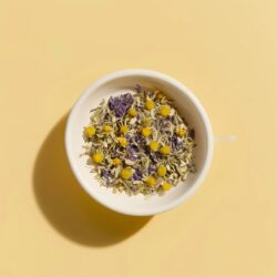 Dried chamomile and cornflower herbal tea blend in a white bowl