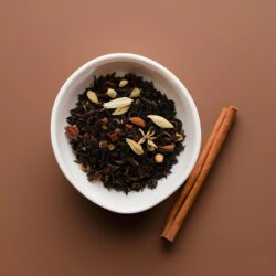 Black tea leaves with cardamom, cinnamon stick, and star anise spices