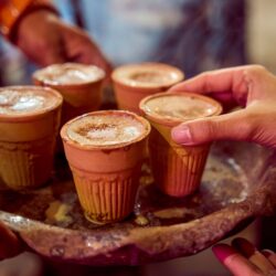 Traditional Indian masala chai served in small clay kulhad cups on a tray