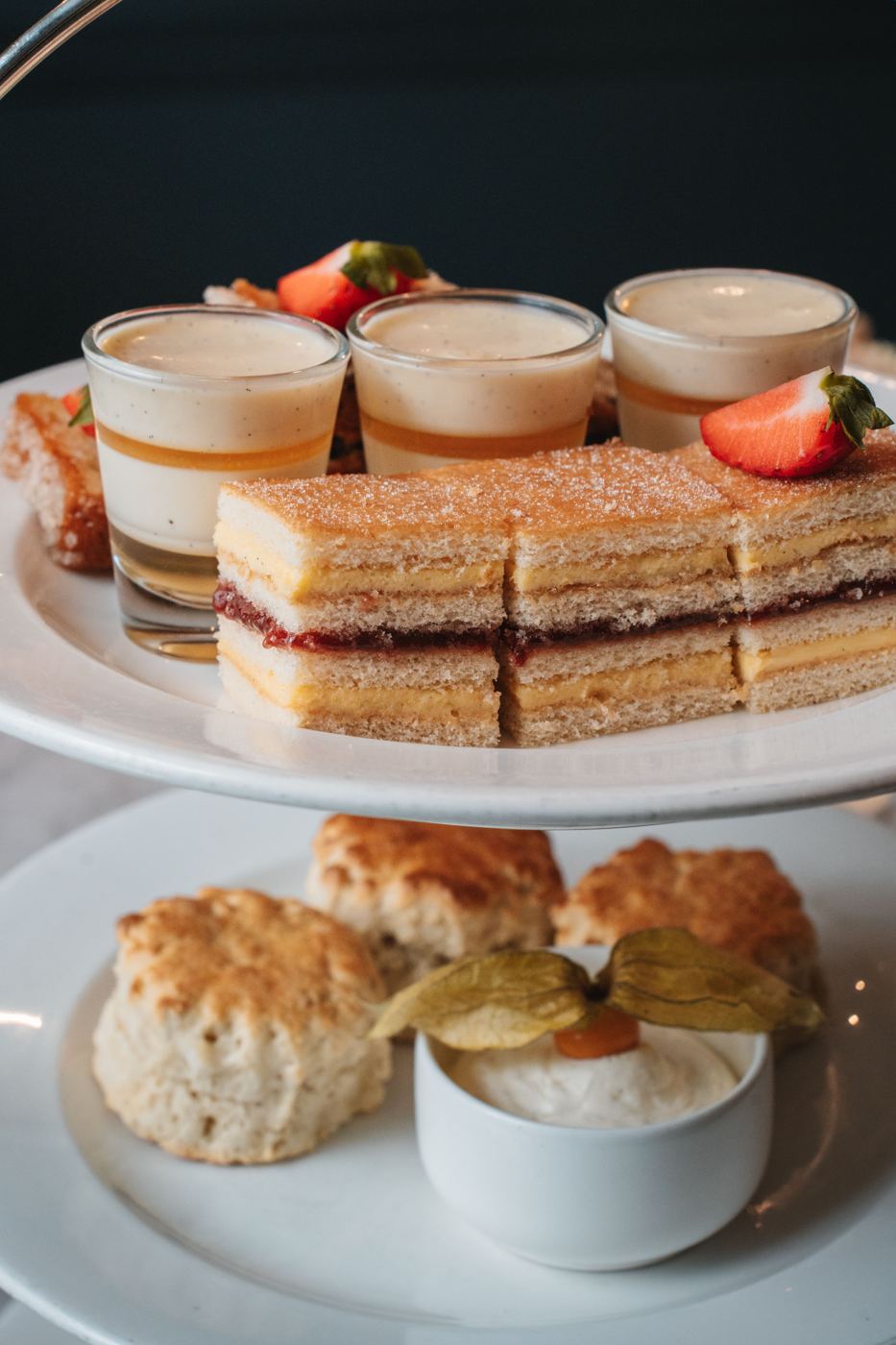 Two-tier stand with tea sandwiches, custard, and scones for high tea