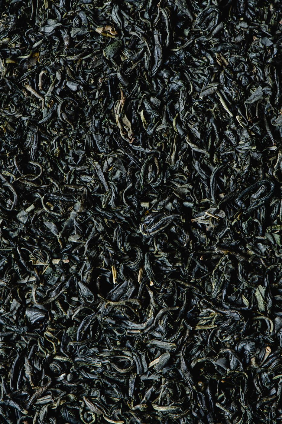 Close-up of dark, curled dried black tea leaves