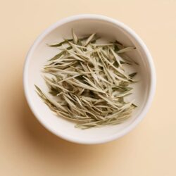 White tea leaves, silver-needle style, in a white bowl