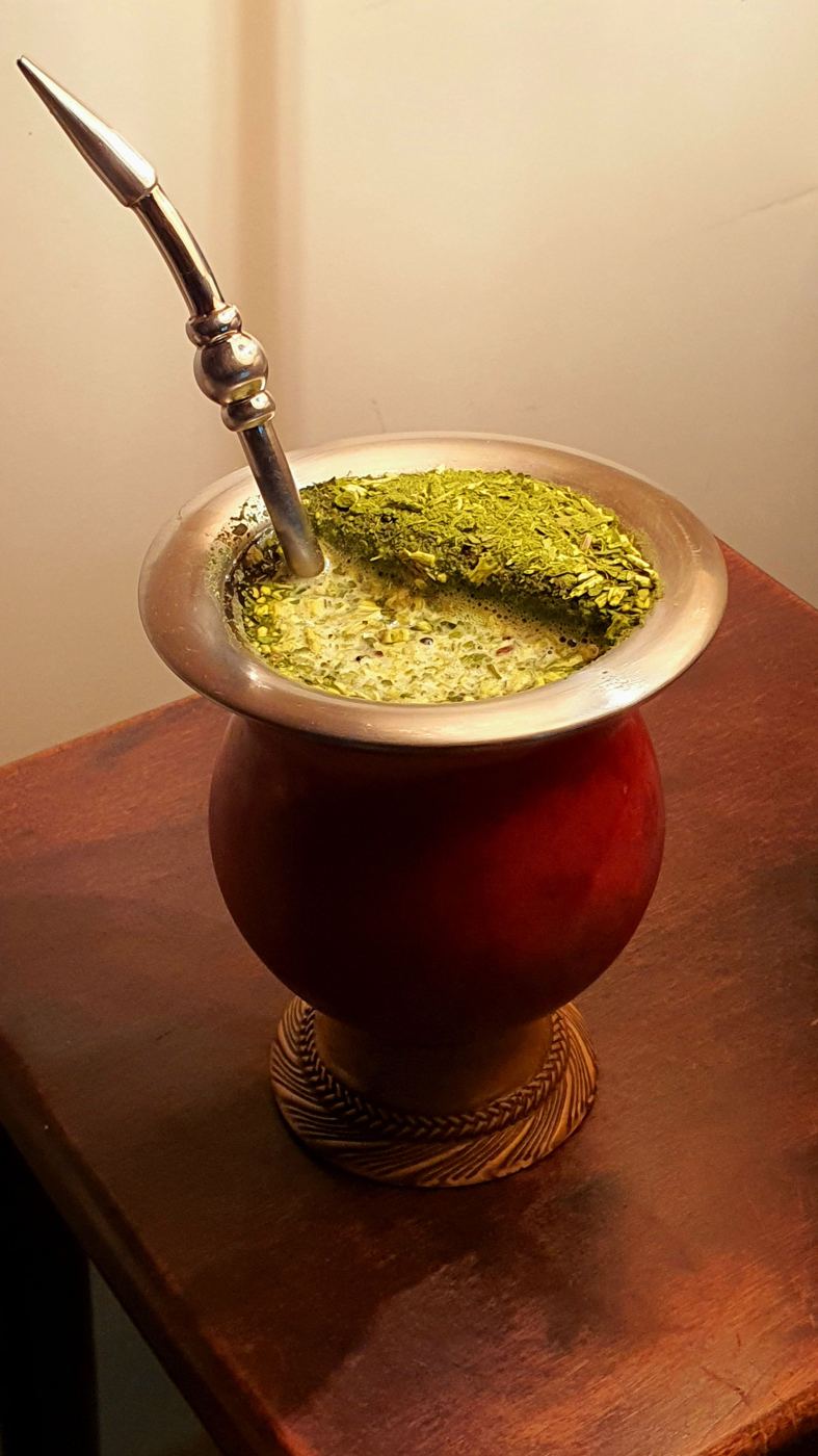 Traditional mate gourd filled with yerba mate and metal bombilla straw