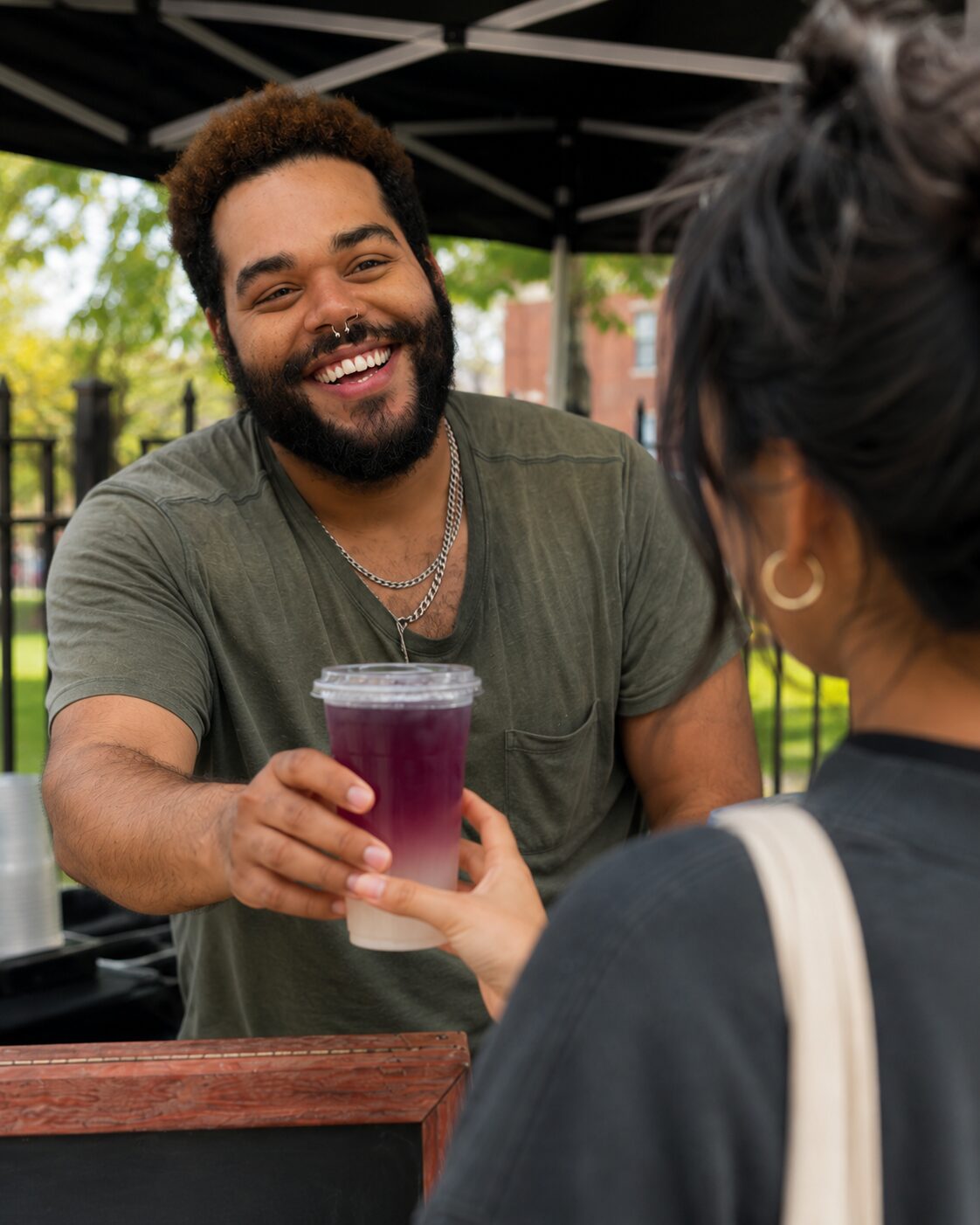 John handing out a tea at a Moody Teas market